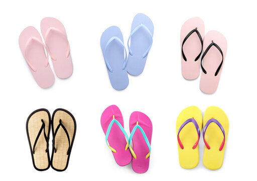 Set with pairs of stylish flip flops on white background, top view