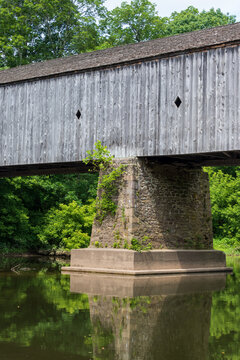 Vertical Shot Of The Schofield Ford Covered Bridge In Tyler State Park, Pennsylvania On A Sunny Day