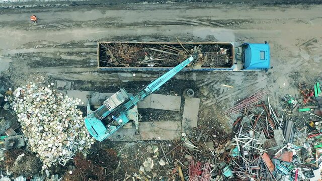 Scrap metal is getting transported into a machine in a top view