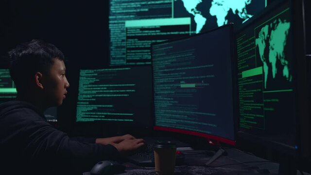 Asian Boy Hacker Using Multiple Computer Hacking And Success Downloading Data

