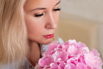Fototapeta premium Close up view of beautiful female face with red lips, after brows correction and lashes extension