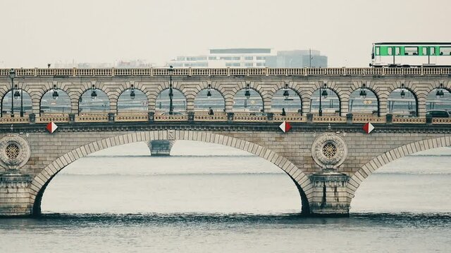 Rainy scene of metro train on the Pont de Bercy bridge over the Seine river in Paris, France