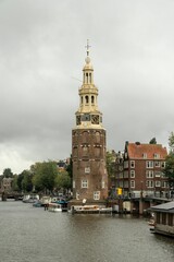 Fototapeta na wymiar The Montelbaanstoren is a tower on the shore of the Oudeschans, Amsterdam canal in the Netherlands. 