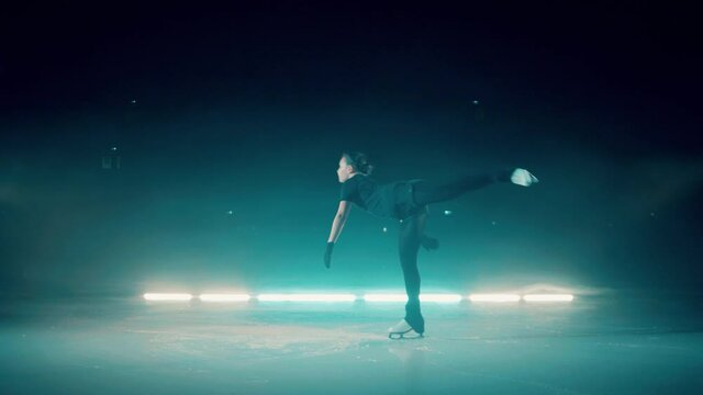 Young girl is spinning on the skating rink