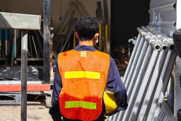 yellow helmet safety in construction site. helmet and reflective vest. content work safety. buider...