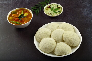 Plate of delicious and healthy idly served with coconut chutney and sambar- Kerala, Tamilnadu...