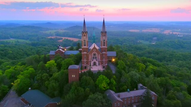 Holy Hill Basilica, quiet beauty and soaring architecture in the twilight sky, moving aerial view.
