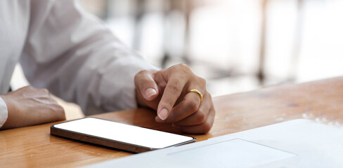 woman using smartphone blank screen frameless modern design while lying in office