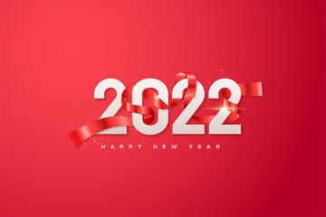 Happy new year 2022 with white numbers wrapped in red ribbon.