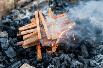 Starting the camp fire with kindling. Camping life.