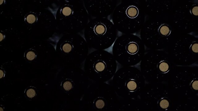 Top down view of corked bottles of fresh new wine on a conveyor belt - isolated