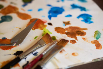 Fototapeta premium Table with brushes and canvas in an art workshop. Background.