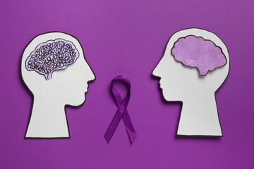 Human head cutouts with different brains and purple ribbon on color background, flat lay. Epilepsy...