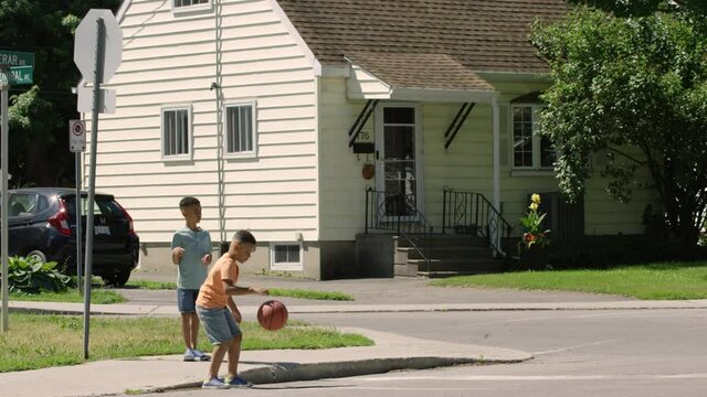 Young African American Kid chasing ball into the street