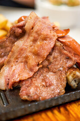 Delicious American barbecue platter, steak, bacon, sausage and fries platter