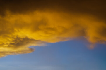 Fototapeta na wymiar Yellow cloud from sunshine in evening with blue sky when start to rain in monsoon season.
