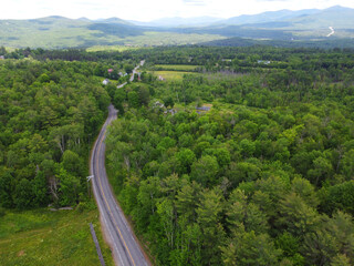 Fototapeta na wymiar aerial of country road in the forest and mountain