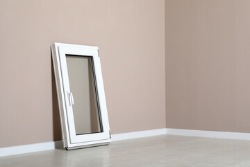 Modern single casement window near beige wall indoors, space for text