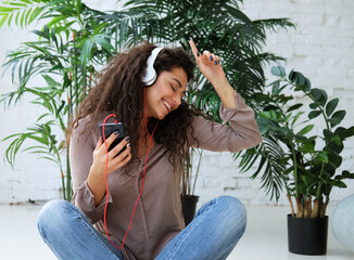 Young beautiful african american woman relaxing and listening to music