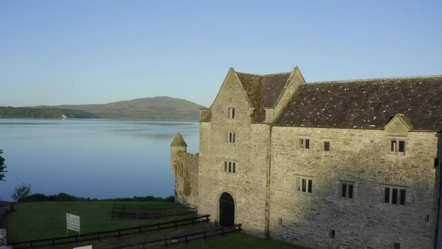 Parke's Castle, Dromahair, Leitrim, Ireland, June 2021. Drone slowly orbits towards the Castle Facade and lifts up to reveal the interior courtyard and western vista of Lough Gill.