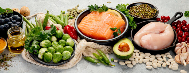 Selection of healthy food on light gray background. Clean eating concept.