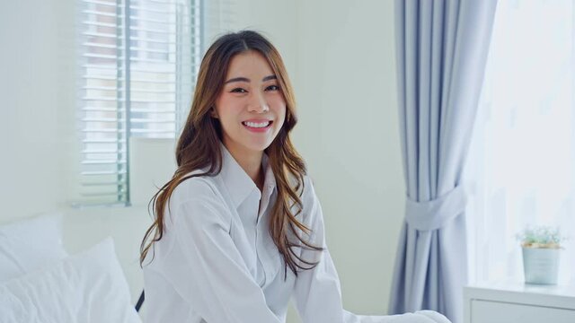 Portrait of Asian Beautiful girl in pajamas smile and look at camera.