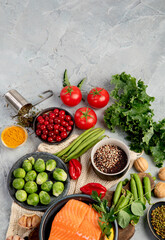 Selection of healthy food on light gray background. Clean eating concept.