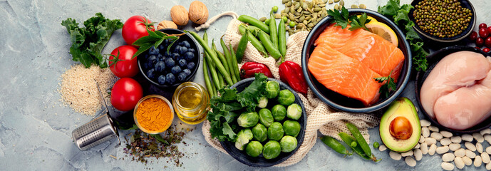 Selection of healthy food on light gray background. Clean eating concept.