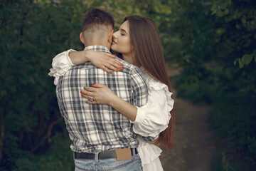 Beautiful couple spend time in a summer park