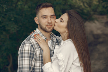 Beautiful couple spend time in a summer park