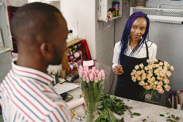 Portrait of joyful African American people in flower store