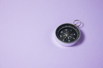 Compass on purple background. Concept signs symbols.