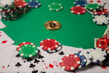 Classic playing cards, chips, red dice, bitcoin and dollars on green background.