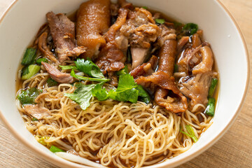 Stewed pork leg noodles in brown soup
