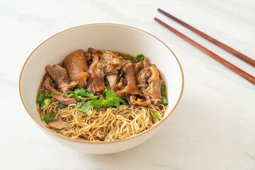 Stewed pork leg noodles in brown soup