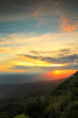 Sunset sunrise twilight sky cloud color background with forest mountain hill landscape in national park Thailand