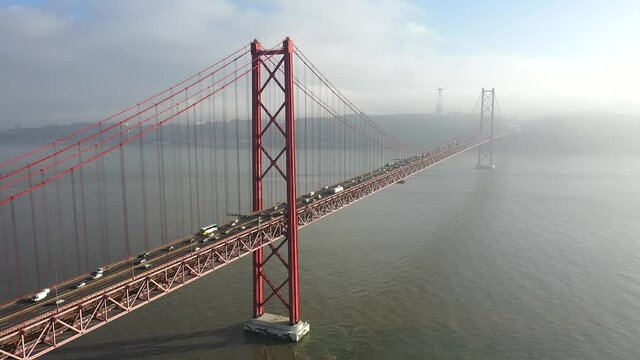 Close aerial shot 25 de Abril bridge in Lisbon, Portugal during a cloudy day