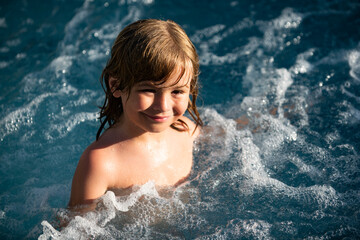 Child swimming. Kids summer vacation in swimming pool.
