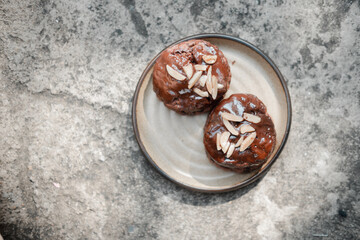 Close up of round shaped chocolate scones styled with nut