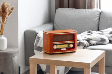 Retro radio receiver on table in living room
