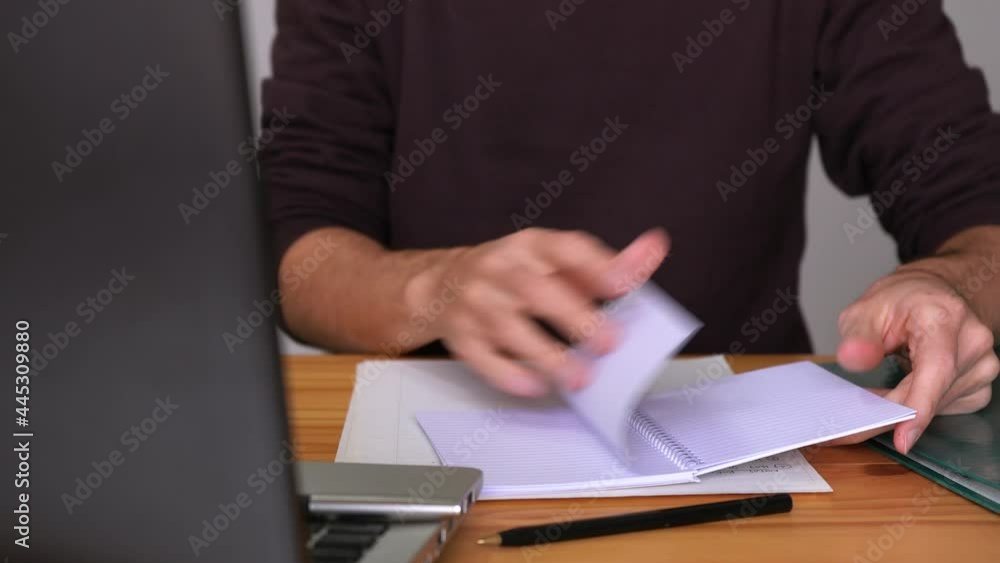 Poster hands flipping blank pages of a notebook on the table. close up