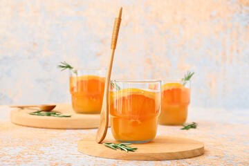 Glasses of tasty grapefruit juice on light background