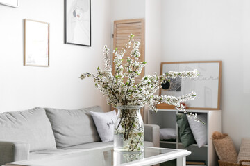 Interior of modern living room with blossoming branches
