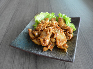 stir fried chicken meat with garlic and honey sauce on wood background asian halal menu