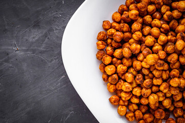 fried chickpeas on a dark stone background