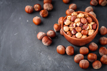 fresh natural hazelnuts on a dark stone background