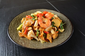 stir fried noodle kway teow with seafood phad Thai on wood background asian halal menu