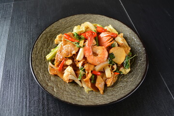 stir fried noodle kway teow with seafood phad Thai on wood background asian halal menu