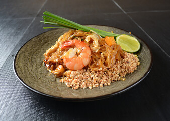 stir fried noodle kway teow with seafood phad Thai on wood background asian halal menu