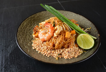stir fried noodle kway teow with seafood phad Thai on wood background asian halal menu